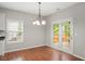 Bright dining area featuring hardwood floors and a decorative chandelier, bathed in natural light at 404 Straywhite Ave, Apex, NC 27539