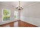 Elegant dining room featuring hardwood floors, chair rail detail, and a chandelier at 404 Straywhite Ave, Apex, NC 27539