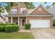 Traditional home with a two-car garage, red brick facade, and well-maintained greenery at 404 Straywhite Ave, Apex, NC 27539