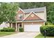 Charming two-story home with brick and siding, manicured lawn, and attached two-car garage at 404 Straywhite Ave, Apex, NC 27539