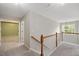 Upstairs hallway featuring a staircase and views of rooms filled with natural light at 404 Straywhite Ave, Apex, NC 27539