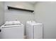 A practical laundry room with a modern washer and dryer set and overhead storage at 404 Straywhite Ave, Apex, NC 27539