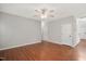 Spacious living room with hardwood floors, neutral paint, and a ceiling fan for comfortable living at 404 Straywhite Ave, Apex, NC 27539