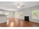 Spacious open-concept living area with a fireplace, hardwood floors, and views into the dining area at 404 Straywhite Ave, Apex, NC 27539