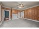 Bedroom showcases classic wood paneling, neutral carpet, and multiple entryways at 421 E Morehead St, Burlington, NC 27215