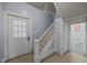 Charming entryway featuring a white door, staircase, and an adjacent bathroom entrance at 421 E Morehead St, Burlington, NC 27215