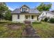 Charming two-story home featuring a classic design, inviting front porch and gray shingled roof at 421 E Morehead St, Burlington, NC 27215