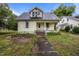 Charming two-story home featuring a classic design, inviting front porch and gray shingled roof at 421 E Morehead St, Burlington, NC 27215