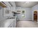 Kitchen with light blue walls, white cabinets, laminate countertop and a sink at 421 E Morehead St, Burlington, NC 27215