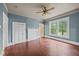 Living room showcasing hardwood floors, blue walls, and large windows for lots of light at 421 E Morehead St, Burlington, NC 27215