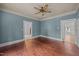 Living room with natural light and wooden floor, featuring blue walls at 421 E Morehead St, Burlington, NC 27215