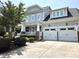 Two-story home with a two-car garage and a covered porch, showcasing curb appeal and a well-maintained lawn at 4562 Brighton Ridge Dr, Apex, NC 27539
