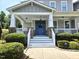 Charming home entrance featuring a blue door with a wreath and a welcoming front porch with white railings at 4562 Brighton Ridge Dr, Apex, NC 27539