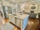 Open kitchen and living area with granite countertops, stainless appliances, and a cozy fireplace at 4562 Brighton Ridge Dr, Apex, NC 27539