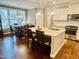 Bright kitchen with granite countertops, stainless appliances, island seating, and an adjacent dining area at 4562 Brighton Ridge Dr, Apex, NC 27539