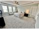 Spacious main bedroom with large windows, a ceiling fan, and carpeted floors at 4562 Brighton Ridge Dr, Apex, NC 27539