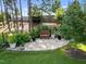Secluded backyard with a stone patio, garden, mature trees and verdant lawn at 461 Cedar Pond Ct, Knightdale, NC 27545
