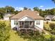 Back exterior view of home, highlighting the deck, screened-in porch, landscaped yard, and barbecue grill at 461 Cedar Pond Ct, Knightdale, NC 27545