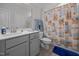 Well-lit bathroom with a neutral-toned vanity, decorative shower curtain, and tiled floors at 461 Cedar Pond Ct, Knightdale, NC 27545