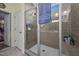 Bathroom featuring a large walk-in shower with tiled walls, a glass door, and a rainfall shower head at 461 Cedar Pond Ct, Knightdale, NC 27545
