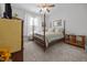 Comfortable bedroom features a four-poster bed, soft carpet, and natural light at 461 Cedar Pond Ct, Knightdale, NC 27545