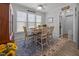 Bright dining area with large windows, a cozy rug, and stylish decor at 461 Cedar Pond Ct, Knightdale, NC 27545