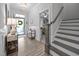 Home foyer featuring wood flooring, a staircase, and entry to another room at 461 Cedar Pond Ct, Knightdale, NC 27545