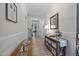 Inviting hallway featuring wood floors, a decorative table, and neutral paint colors at 461 Cedar Pond Ct, Knightdale, NC 27545