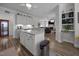 Open-concept kitchen with granite countertops, white cabinetry, and a view to the living room at 461 Cedar Pond Ct, Knightdale, NC 27545