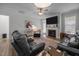 Cozy living room features a fireplace, ceiling fan, and comfortable seating area with accent rug at 461 Cedar Pond Ct, Knightdale, NC 27545