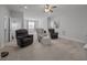Large living room with carpeted floors, neutral walls, and three chairs with an ottoman at 461 Cedar Pond Ct, Knightdale, NC 27545