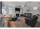 Cozy living room features a fireplace, ceiling fan, and comfortable seating area with accent rug at 461 Cedar Pond Ct, Knightdale, NC 27545