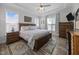 Spacious bedroom with hardwood floors, trey ceiling, ceiling fan, and natural light from large windows at 461 Cedar Pond Ct, Knightdale, NC 27545