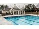 Community pool with lane markers surrounded by a large, concrete deck, with a nearby cabana at 461 Cedar Pond Ct, Knightdale, NC 27545