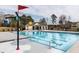 Community pool with lane markers and diving board with a splash bucket near a community cabana at 461 Cedar Pond Ct, Knightdale, NC 27545