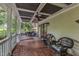 Spacious covered porch boasts wood floors, comfortable seating, and a porch swing for outdoor relaxation at 4620 Gomar Ln, Fuquay Varina, NC 27526