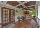 Charming back porch features a brick fireplace, ceiling fan, and comfortable seating with wood flooring at 4620 Gomar Ln, Fuquay Varina, NC 27526