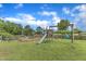 Expansive backyard featuring a wooden playset, swing, and open green space for outdoor activities at 4620 Gomar Ln, Fuquay Varina, NC 27526