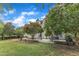 Large, well-maintained backyard with mature trees and a patio area, perfect for outdoor entertaining and relaxation at 4620 Gomar Ln, Fuquay Varina, NC 27526