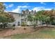 Manicured backyard boasting mature trees, a two-story house, and a welcoming patio area for outdoor gatherings and relaxation at 4620 Gomar Ln, Fuquay Varina, NC 27526