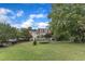Spacious backyard with lush lawn and landscaping, including a trampoline, offering ample space for recreation and outdoor activities at 4620 Gomar Ln, Fuquay Varina, NC 27526