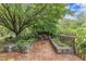 Cozy backyard retreat features a brick patio, stone accents, and lush greenery around the fire pit area at 4620 Gomar Ln, Fuquay Varina, NC 27526