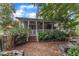 Charming outdoor space with a brick patio, covered porch with seating, and beautiful landscaping at 4620 Gomar Ln, Fuquay Varina, NC 27526