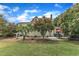 Beautiful backyard with a manicured lawn, outdoor dining area, and mature trees creating a private retreat at 4620 Gomar Ln, Fuquay Varina, NC 27526