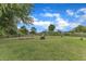 Spacious, grassy backyard featuring a playset and treelined border at 4620 Gomar Ln, Fuquay Varina, NC 27526