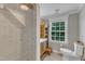 Well-lit bathroom features a shower, window, vanity with sink, and a toilet at 4620 Gomar Ln, Fuquay Varina, NC 27526