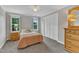 Comfortable bedroom with neutral walls, carpet flooring, windows that let in natural light, and ample storage at 4620 Gomar Ln, Fuquay Varina, NC 27526