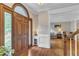 Stunning entryway with wood door, hardwood floors, and entry to living room at 4620 Gomar Ln, Fuquay Varina, NC 27526