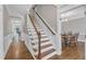 Inviting entryway with hardwood floors, staircase, and trimwork detail with dining room off to the side at 4620 Gomar Ln, Fuquay Varina, NC 27526