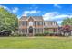 Charming brick two-story home with manicured lawn and mature trees in a quiet neighborhood at 4620 Gomar Ln, Fuquay Varina, NC 27526